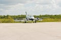 Airplane parked on end of a tropical airport airstrip