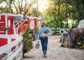 Front view of farmer walking outdoors on small family farm. Royalty Free Stock Photo