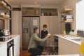 Father and son arranging dirty dishes in dishwasher Royalty Free Stock Photo