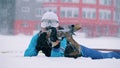 Front view of a female biathlete shooting during the snowfall