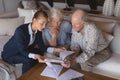 Female doctor and senior couple discussing over medical reports Royalty Free Stock Photo