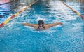 Front view of a female swimmer swimming butterfly style Royalty Free Stock Photo