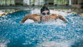 Front view of a female swimmer swimming butterfly style Royalty Free Stock Photo
