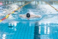 Front view of a female swimmer swimming butterfly style Royalty Free Stock Photo