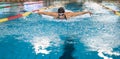 Front view of a female swimmer swimming butterfly style Royalty Free Stock Photo