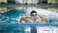 Front view of a female swimmer swimming butterfly style Royalty Free Stock Photo