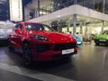 Front view of the five-seat sports cross-over Porsche Kayenne orange in the auto show on February 05, 2020 in Russia, Kazan,