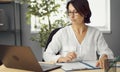 Woman working papers looking laptop Royalty Free Stock Photo