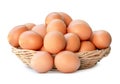 Front view of fresh brown chicken eggs in stack in woven bamboo basket isolated on white background with clipping path Royalty Free Stock Photo