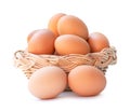 Front view of fresh brown chicken eggs in stack in woven bamboo basket isolated on white background with clipping path Royalty Free Stock Photo