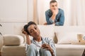 front view of frustraited african american couple beside couch Royalty Free Stock Photo