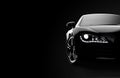 Front view of a generic and brandless modern black car on a dark background Royalty Free Stock Photo