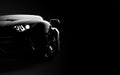 Front view of a generic and brandless modern sport car on a dark background Royalty Free Stock Photo