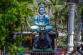 Front view of giant statue of lord shiva and his vehicle nandi bull under bright sunlight surrounded by green trees at kanheri Royalty Free Stock Photo