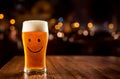 Front view on glass of chilled light happy beer with foam head on bokeh background. Tulip pint glass of fresh frothy yellow