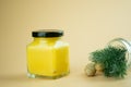 Front view of a glass jar with black lid of lemon curd with honey dipper stick Royalty Free Stock Photo