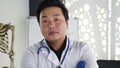 Attractive portrait of handsome young high-skilled asian doctor in white gown and stethoscope which posing on camera