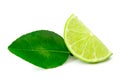 Front view of green lemon slice or quarter with leaf isolated on white background with clipping path Royalty Free Stock Photo