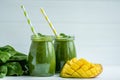 Front view of green smoothies with mango, spinach on white background. Healthy food. Vegetarian diet Royalty Free Stock Photo