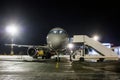 Front view of ground handling passenger airplane at night Royalty Free Stock Photo