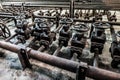 Front view of group of valves in old industrial rusty pipes