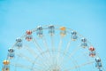 Front view of half retro colorful ferris wheel at amusement park over blue sky background, copy space, vintage effect Royalty Free Stock Photo