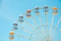 Front view of half retro colorful ferris wheel at amusement park over blue sky background, copy space, vintage effect Royalty Free Stock Photo