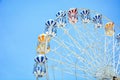 Front view of half retro colorful ferris wheel at amusement park over blue sky background, copy space, vintage effect Royalty Free Stock Photo