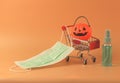 Halloween pumpkin on shopping cart with medical face mask and alcohol hand spray on orange background with copy space. Covid19