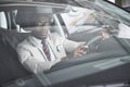 Front view of Handsome african elegant serious business man drives a car Royalty Free Stock Photo