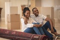 Happy African American couple sitting on floor and looking away Royalty Free Stock Photo