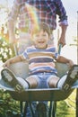 Front view of boy have fun while driving on wheelbarrows Royalty Free Stock Photo