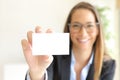 Happy businesswoman showing blank card at office Royalty Free Stock Photo