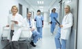 Doctors and surgeons looking at camera in the corridor at hospital Royalty Free Stock Photo