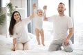 Happy family couple having fun and lifting baby by arms Royalty Free Stock Photo