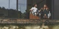 Front view of happy family sitting outdoor on the terrace of big country house Royalty Free Stock Photo