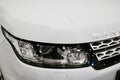 Front view headlight of a white Land Rover Range Rover Sport 2017. Car exterior details. Royalty Free Stock Photo