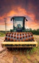 Front View: Heavy construction vehicle of a Sheepsfoot Roller Drum for compacting soil.