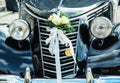 Front view of historical wedding car with ribbon and flowers Royalty Free Stock Photo