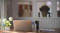 Front view home office with laptop,  pencil holder, document file and flower pot. Royalty Free Stock Photo
