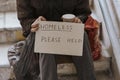 front view homeless man holding help sign plastic bag. High quality photo