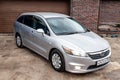 Front view of a Honda Stream car in a silver body Japanese 2008 year van in a parking Royalty Free Stock Photo