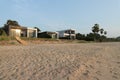 Front view of house on the beach and a setting sun, Royalty Free Stock Photo
