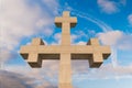 Front view of huge stone cross monument against white clouds, Georgia, Gonio