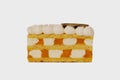 Front view image of layered cake piece with whipped cream topping and apricot jam isolated at white background Royalty Free Stock Photo