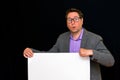 Front view image of worried caucasian Business man holding a blank banner isolated on black background