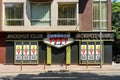 The front view of a Jackpot Club entrance. Signage boards on front above the casino door and instead of its windows. On a sunny