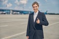 Smiling female airport worker on the runway Royalty Free Stock Photo