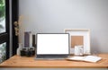 Front view laptop computer, picture frame, coffee cup and camera on wooden table Royalty Free Stock Photo