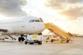 Front view of large white passenger airplane and air-stairs to the door, towable steps allowing passengers to board Royalty Free Stock Photo